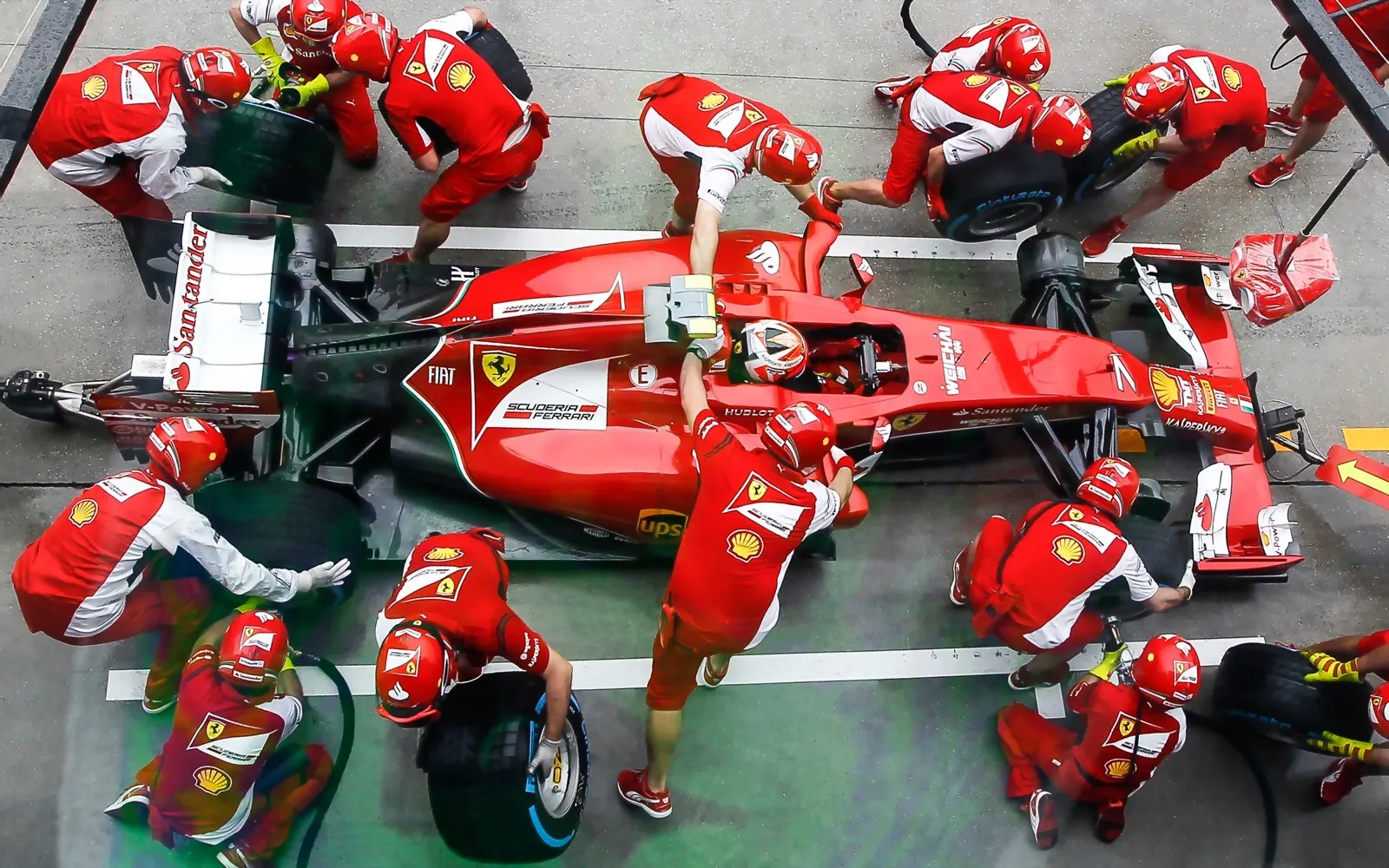 An F1 pit crew working on a car during a pit stop