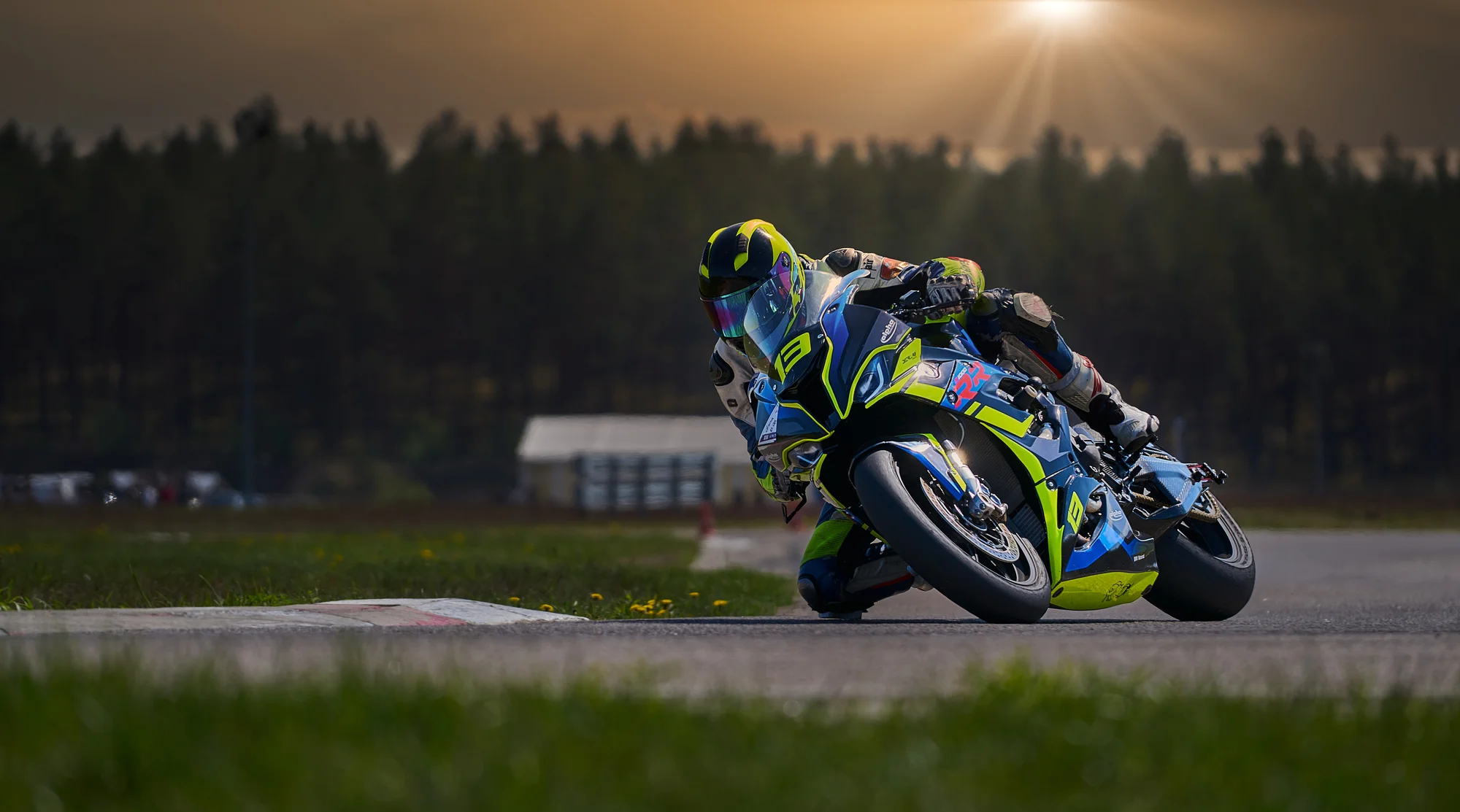 Motorcycle racer scraping curb in full lean